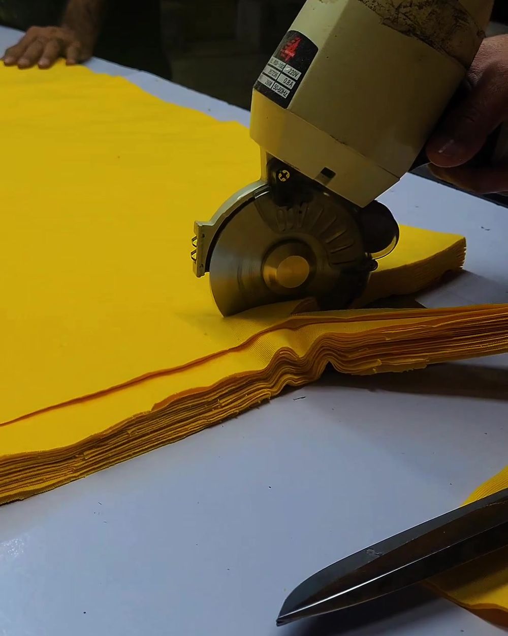 Cutting fabric for a bulk order at Fixen International